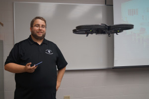 Adam Maksl, assistant professor of journalism , flies his drone in class. 