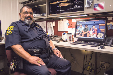 Officer Ruben sits at his desk in his office on campus.