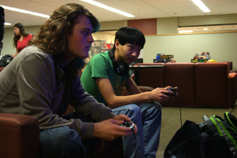 Photo by Katie Casper Sevyn Tripton, biology junior, with Jackson Kerly, informatics and computer networking sophomore, playing Super Smash Bros on the Wii during Thursday night game night. 