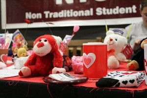 A stuffed monkey and fake candle was for sale at the NTSU Valentine’s Day event table. 