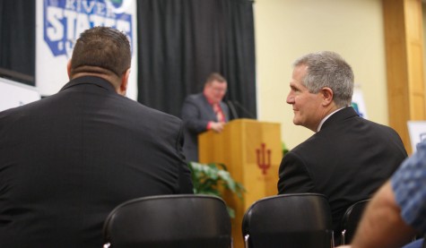 Commissioner Scott McClure and Athletic Director Joe Glover share a look at the press conference. 
