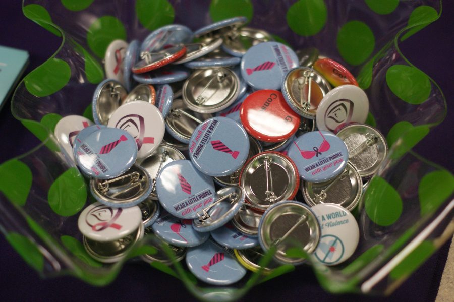 The+Center+for+Women+and+Families+pass+out+buttons+to+advocate+against+sexual+and+domestic+violence.