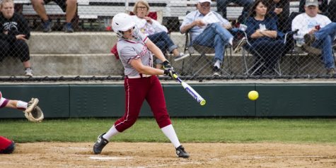 Emily Weiss, sophomore, takes a swing at an incoming pitch.