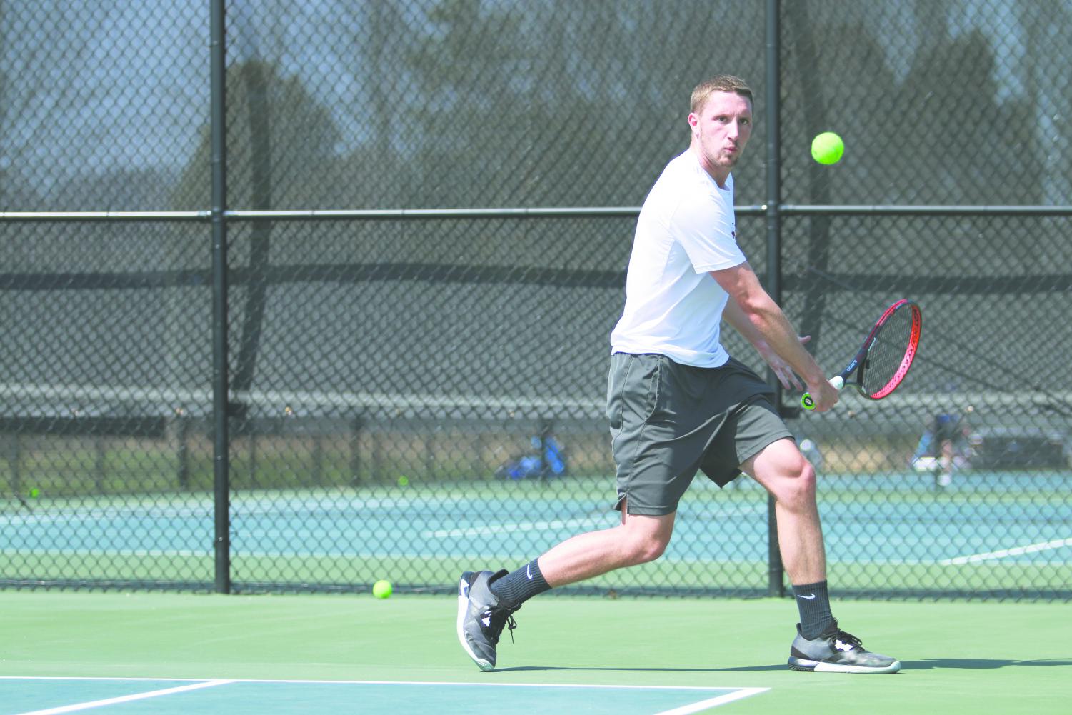 Junior Sam Venter sets up a backhanded return in a Spring 2018 match. Venter is one of four juniors who Epkey believes will lead the men's team this season.