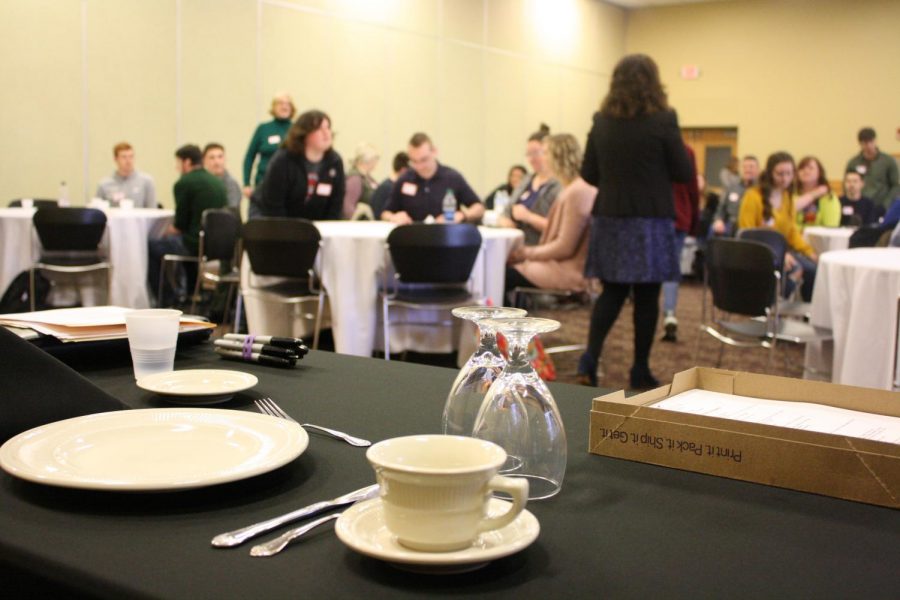 Places%2C+glasses+and+dining+utensils+are+center+stage+as+Mary+Starvaggi+speaks+to+students+in+the+Hoosier+Room+during+the+etiquette+workshop.
