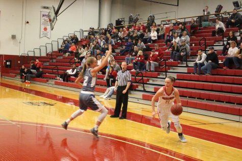 Junior Ariana Sandefur proceeds to drive past her defender in the first half against Asbury.