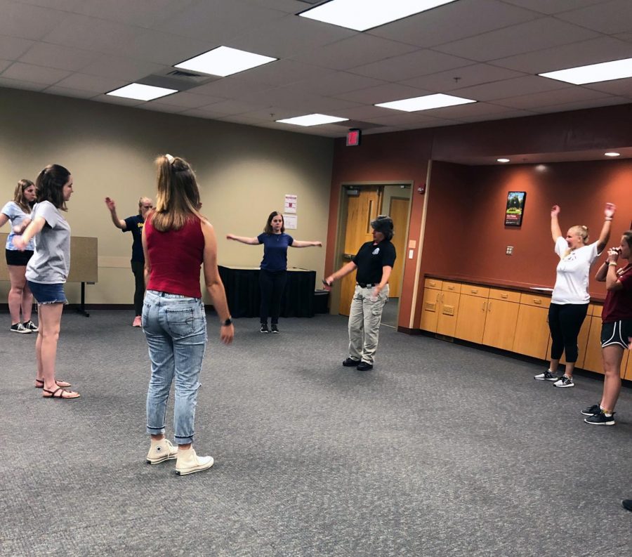 Monica+Burnell-Wise+leads+off+exercises+to+get+students+warmed+up+for+the+physical+portion+of+the+women%E2%80%99s+self-defense+class.