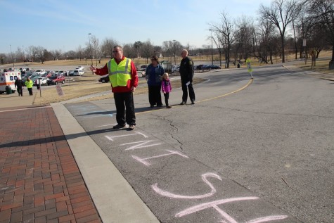 Chancellor Ray Wallace directs racers at the finish line. 