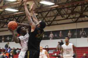 Demetrius Stanton, sophomore guard, goes up for a shot against a St. Catharine defender. Stanton had a game-high 25 points in the loss.