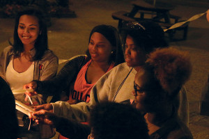 Brittany Shepard, undeclared junior, Alnisha Franklin, accounting sophomore, Tassy Payne, journalism sophomore, and Veronica Victor, psychology freshman, bring all their candles together to represent unity before blowing them out.