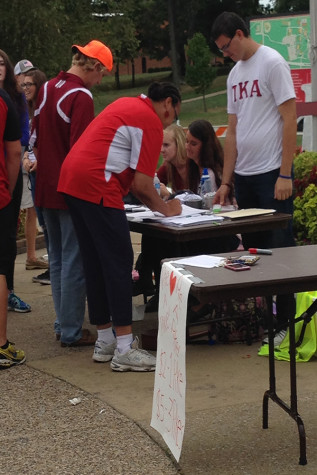 Dakota Brooks, education junior and 21st Century Scholar support specialist, and Channell Barbour, associate director of Campus Life, sign up for the fire truck pull.