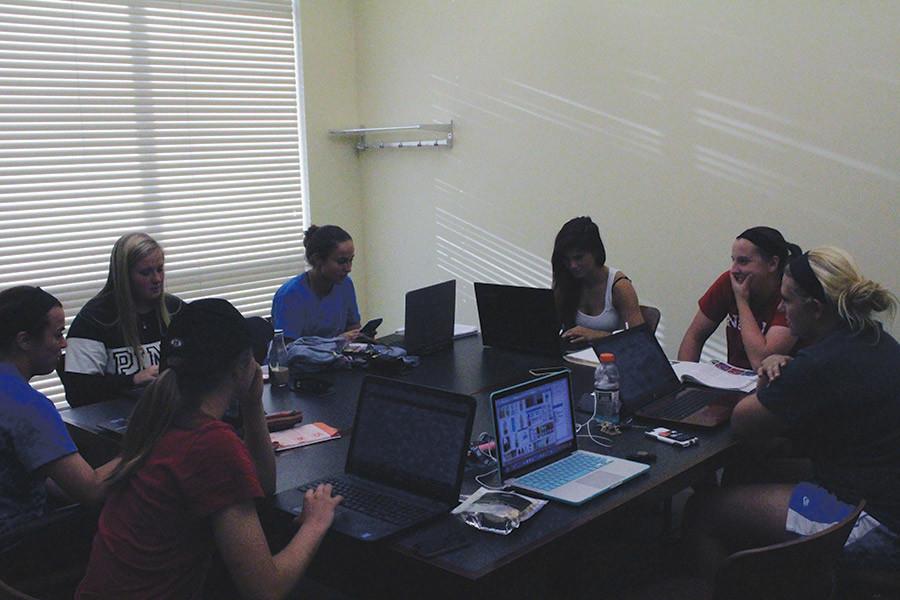 Some+players+from+the+IUS+softball+team+gather+around+a+study+table+in+the+the+library.+Outfielder+Montanah+Rogers%2C+biology+sophomore%2C+said+that+the+softball+team+is+required+to+go+to+study+tables+for+at+least+two+hours%2C+two+days+a+week.