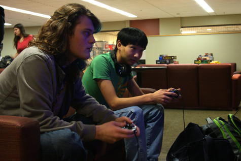 Photo by Katie Casper Sevyn Tripton, biology junior, with Jackson Kerly, informatics and computer networking sophomore, playing Super Smash Bros on the Wii during Thursday night game night.