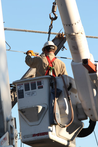 Duke Energy crews working to rewire the telephone poles and get power back to campus.