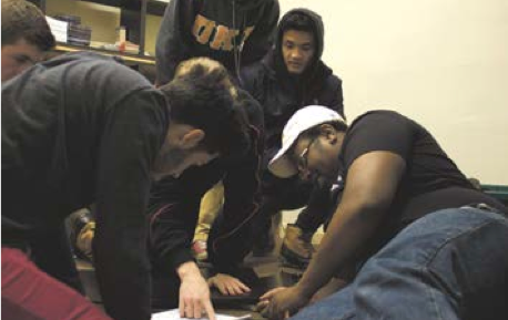 Members of Phi Kappa Alpha lend a helping hand by putting together office furniture at Our Place Drug and Alcohol Services.