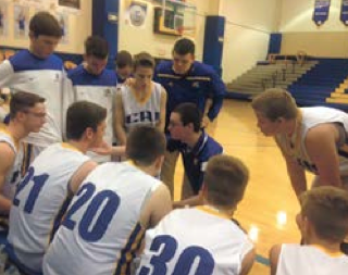 Hayden Casey, secondary education junior, in a huddle with his 8th grade basketball team from a game this season. Casey said that his team won the game, which put them at a record of 9-2 for this season. Photo courtesy of Hayden Casey