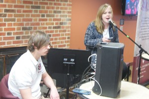 Richard Stottman, music junior and arts and entertainment organizer of the SPC, monitors the speaker as Kelly Howard, psychology junior, sings “I Want You To Stay” to students in The Commons during the SPC’s Open Mic. 