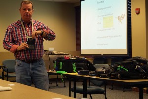 Dale Brown, geosciences senior, demonstrates how a passport holder is helpful when traveling abroad. 