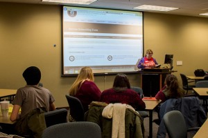 Danielle Devers, biology junior and Success Networking Team coordinator of the IU Southeast chapter of the National Society of Leadership and Success, gives a presentation about SNT meetings before the Juju Chang speaker broadcast begins.