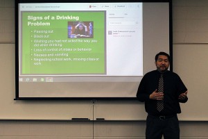 Seuth Chaleunphonh speaks while giving a PowerPoint presentation on alcohol education on Friday, Feb. 12. 