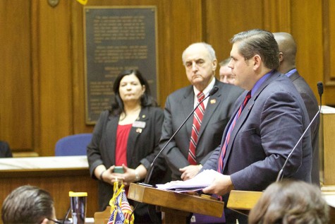 IUS Executive Assistant Donna Harvey and IU President Michael McRobbie listen as Rep. Ed Clere introduces the resolution.