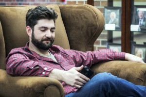 Upstairs of UC North, Tyler was unwinding in the lobby by the breezeway, checking his phone.