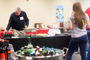 Glenn Mason, professor of geosciences, selects one of the regional dishes offered at the event. 