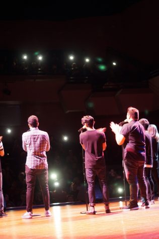 Flashlights light up the audience as The Filharmonic sings “Flashlight” from “Pitch Perfect 2.”