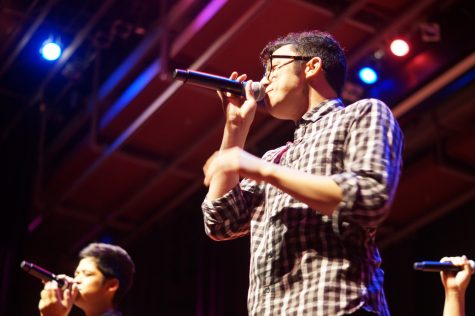 Barry Fortgang smiles at the audience while singing.