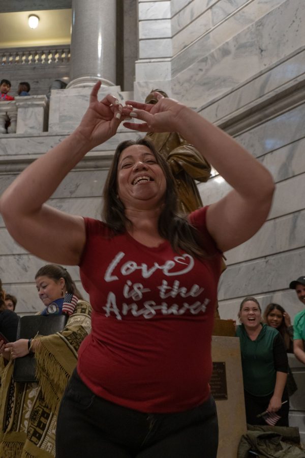 Cuban refugee Adelaine Olivia dances to music during the beginning of the rally. A live band played a few songs before the event began.