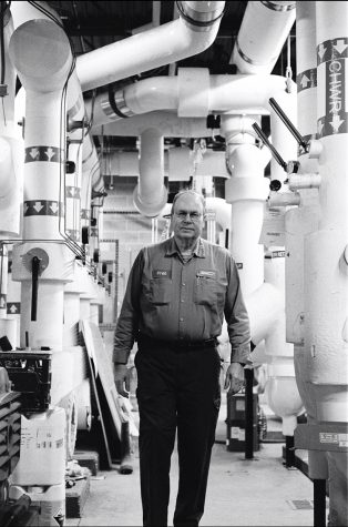 Fred Jackson walks in the facility operations building during his shift at night. Photo by John Clere.