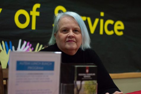 Graduate student Anita Kraft sits at her table outside the "O"