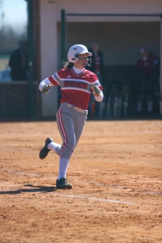 Sophomore Kaitlyn Flowers prepares to round first base after hitting a single back up the middle in game one of last Saturday's doubleheader versus Point Park University.