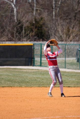 Second baseman Lindsey Nelson shields her eyes from the sun before catching an infield popup in game two of last Saturday's doubleheader versus Asbury University.