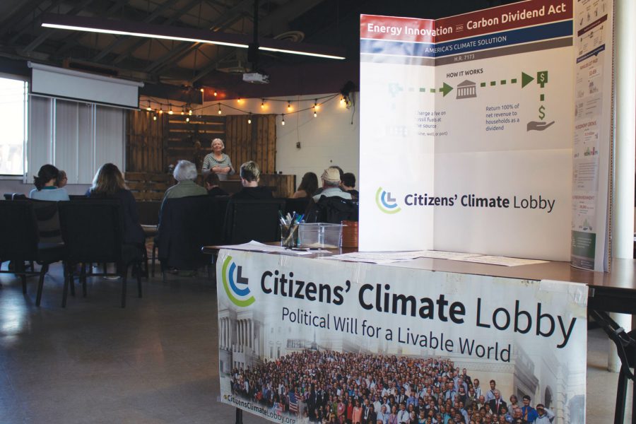 As Veldman runs the climate workshop, the CCL's information booth stands at the entrance, greeting new attendees. Flyers and packets were handed out to all in attendance.