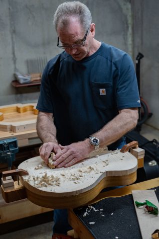 Mabe uses a hand plain to level out the front plate for a guitar. Very little of his work is done with power tools. 
